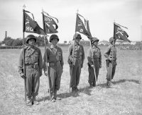 Fifth Army, Rosignano Area, Italy. Standards of Co.'s A, B, C, and D, of the 100th Infantry Battalion, 442nd Regiment, 34th Division, composed of Americans of Japanese descent. Flying battle streamers awarded through a Presidential Citation just tied on by Lt. Gen. Mark W. Clark, commanding General of Fifth Army. July 27, 1944. [Courtesy of NARA. NAID: 148727484.]