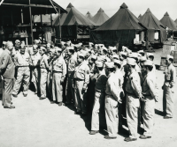 Lt. Col. Farrant Turner, addressing members of the 100th Infantry Battalion upon their return to Hawaiʻi in August 1944, after 18 months away from the islands for training and combat service in the United States Army. Most in the group had been wounded in action and had returned for furlough and reassignment. [Courtesy of DAGS - Hawai‘i State Archives]