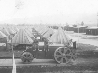 Three soldiers sit on a utility vehicle in Italian camp, 1944. [Courtesy of Mary Hamasaki]