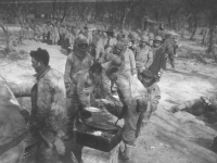 Soldiers line up for chow time in Italy, 1944. [Courtesy of Mary Hamasaki]