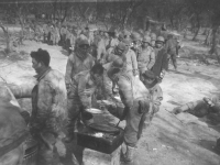 Soldiers line up for chow time in Italy, 1944. [Courtesy of Mary Hamasaki]