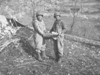 Soldiers show off shrapnel in Cassino, Italy, 1944. [Courtesy of Mary Hamasaki]