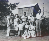 100th soldiers with aprons. Scott Hendersin family. [BACK (L to R): Unknown, Marie Hendersin, Unknown, Unknown, Scott Hendersin. MIDDLE (L to R): JoAnne, Betty and Nancy Hendersin. FRONT: Bobby Hendersin. [Courtesy of Monroe County Local History Museum, Sparta, Wisconsin. Jarrod Roll, Director. Jan 8, 2019]