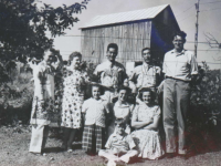 100th soldiers with aprons. Scott Hendersin family. [BACK (L to R): Unknown, Marie Hendersin, Unknown, Unknown, Scott Hendersin. MIDDLE (L to R): JoAnne, Betty and Nancy Hendersin. FRONT: Bobby Hendersin. [Courtesy of Monroe County Local History Museum, Sparta, Wisconsin. Jarrod Roll, Director. Jan 8, 2019]