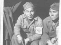 Henry Nakasone and his friend, Paul Kusunoki sit at the entrance to their shelter. [Courtesy of Henry Nakasone]