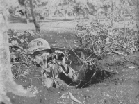 Lt. John Ko of the 100th Bn. Searches for enemy positions. [Courtesy of U.S. Army Signal Corps]