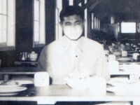 The tables set for the Thanksgiving dinner.  The cooks were cutting the turkey when picture was taken.  Chimney you see in center is the heater.  11/25/42 Camp McCoy, Wis.  [Courtesy of James Nogawa]