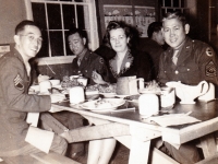 (November 1942) “Thanksgiving Day Party – Left to Right: S/Sgt. Kawakami, S/Sgt. Nishida, Miss Alice Kenny of Sparta USO, and 1st/Sgt. Nakamura. (Note Chow on Table).” Eugene Kawakami is seated on the left.   [Courtesy of Joanne Kai]