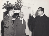 Jack Mizuha, Associate Justice of the Hawaii Supreme Court, swearing in his friend Takashi Kitaoka as the newly appointed judge for the Second Circuit Court on Maui in 1962.  The two men were both born on Maui and were original members in the 100th Infantry Battalion. [Courtesy of Takashi Kitaoka]