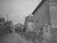 Soldiers march through an Italian town. [Courtesy of Jane Kurahara]