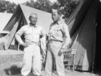 Mits Fukuda standing in front of his tent at Camp McCoy with Sparky Matsunaga [Courtesy of David Fukuda]