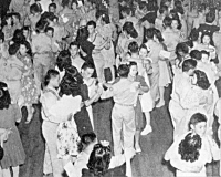 Internee women from Jerome and Rohwer Relocation Centers attend a dance with 442nd soldiers at Camp Shelby, Mississippi [Office of War Information, National Archives, Record Group 208-MO]