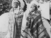 Chief Blow Snake and daughter.  Taken August 9, 1942 at Wisconsin Dells Park.   The Chief (I didn't get his name) and his daughter gladly posed for us.  The dome shaped tent in background is their home.  [Courtesy of Jan Nadamoto]