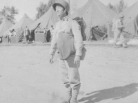 September 1942 Just after a hike with full field pack, gas mask, rifle belt (see canteen pouch hanging in back).  My eyes were closed when photographed.  [Courtesy of Jan Nadamoto]