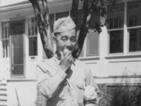 Pretty Good!!  Taken August 16, 1942 at Tomah, Wisconsin.  First bite of apple taken direct from a tree.  Slightly sour-but good.  The bundle is my towel & swimming trunks In it.  [Courtesy of Jan Nadamoto]