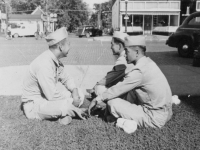 Nothing to do??  Taken August 16, 1942 at Tomah, Wisconsin.  Waiting for the bus to take us back to camp.  Where we're sitting is where the Tomah Post Office is.  [Courtesy of Jan Nadamoto]