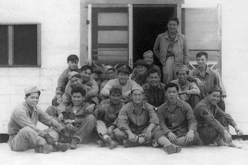 Cat Island and Ship Island Gang, Mississippi, 1942, Bottom row, L to R: William Takaezu, Tokuji Ono, James Komatsu, Fred Kanemura, Koyei Matsumoto, Yasuo Takata. Middle row,  L to R: Unknown, Robert Takashige (with hat), Seiji Tanigawa, John Kihara, Yukio Yokota (with arm on Kihara's shoulder). Top row, L to R:  Seiei Okuma, Takeshi Tanaka (arms around man in front of him), unknown, Masao Hatanaka, Katsumi Maeda, Ray Nosaka, Robert Goshima (standing). [Courtesy of Raymond Nosaka]