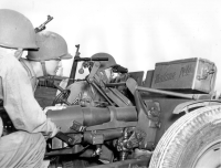 (1943) Japanese Americans in Army train to avenge Pearl Harbor...American citizens, born in the Hawaiian Islands of unquestioned loyalty and patriotism. Formerly part of the Hawaiian National Guard. This anti-tank gun nicknamed "Madame Pele" after a famous Hawaiian Island Volcano, is being fired by Pvt. Wallace Onuma (HQ), Cpl. Tetsuo Hayashi (HQ), and Col. Harry Nakao (HQ). [Courtesy of US Army Signal Corps]