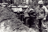 Soldiers took cover in dugouts near Bruyeres [U.S. Army Signal Corps photo]
