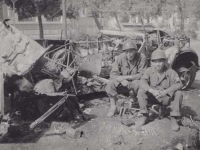 Kimura and Iwamoto sit next to a wrecked German Convoy in Italy, 1945. [Courtesy of Fumie Hamamura]