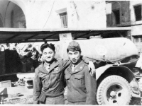 Conrad Kurahara (left) and a friend pose in front of a Go For Broke truck in Italy [Courtesy of Carol Inafuku]