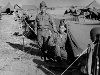 James Inafuku standing next to his tent with his neighbor, Ghedi, Italy, June 1945 [Courtesy of Carol Inafuku] Inscription:Reverse: thedi  (Ghedi) June 1945
