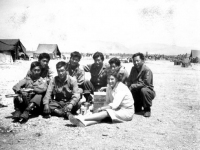 Soldiers pose with a Red Cross volunteer in Ghedi, Italy, June 1945 [Courtesy of Carol Inafuku] Inscription: Reverse: Thedi (Ghedi)June 1945