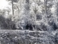 October 12, 1943, Italy. Japanese-American soldiers of the U.S. 100th Infantry Battalion taking position behind an embankment during mock maneuvers. [Photograph by U.S. Army Signal Corps]