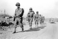 (May 28, 1944) Soldiers of the 100th Infantry Battalion Company D move up to the front in the Velletri area of Italy. [Photograph by U.S. Army Signal Corps]