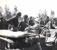 Secretary of War Henry L. Stimson greets Capt. Sakae Takahashi of the 100th’s B Co. (July 1944; Cecina Area, Italy) [Photograph by U.S. Army Signal Corps]