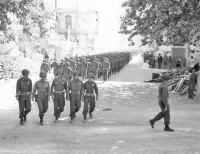 Members of the 100th Infantry Battalion (Separate), composed of American troops of Japanese descent, march through the town of Vada, where Lt. Gen. Mark W. Clark, C. G. of the Fifth Army, presented the Presidential Unit Citation for outstanding action in combat to them. (July 27, 1944) [Photograph by U.S. Army Signal Corps]