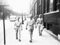 Pvt. Okuma, Pvt. Ono & Pvt. Kihara walking along a Chicago street while on furlough [Courtesy of Alexandra Nakamura] Inscription: Chicago, Pvt. Okumo(Okuma), Pvt. Ono, Pvt. Kihara