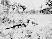 James Kawashima with his rifle in a grassy field. [Courtesy of Alexandra Nakamura]