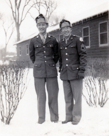 (December 25, 1942) “Sgt. Kenneth Yoshiura and S/Sgt. Kawakami at Camp Savage, Minnesota”. Eugene Kawakami (right), Kenneth Yoshiura (left), and a few others went to visit their friends who transferred from Company A to the MIS. They enjoyed a nice Christmas dinner with them at their training site, Camp Savage. [Courtesy of Joanne Kai]