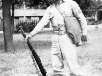 Sonsei Nakamura Standing at Attention with rifle at Camp McCoy, Wisconsin [Courtesy of Sonsei Nakamura]