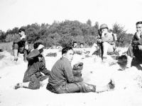 Uchida, Ogata, Tani, Nakamura sitting on the ground resting [Courtesy of Sonsei Nakamura]