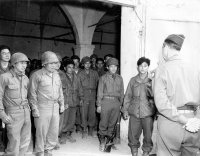 (April 3, 1945) Lucca area, Italy. Gen. Mark W. Clark, Commanding General (CG) of the Fifteenth Army Group (touring the 92nd Division area) welcomes the men of the 442nd Regiment, and the 100th Battalion, who are now under his command. General Clark formerly commanded them while he was CG of the Fifth Army, and they were then with the 34th Division. [U.S. Army photo]