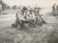 Camp McCoy, during rest period on hike - Sgt. Ronald Kiyabu, Sgt. Shimogaki, Staff Sgt. Larry Mizuno, PFC Komori. (Courtesy of Alvin Shimogaki)