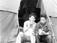Yoshito Morikawa and Richard Yamamoto eating in front of their tent at Camp McCoy, Wisconsin [Courtesy of Goro Sumida] Inscription: Yoshito Morikawa, Richard Yamamoto. Reverse: Yoshito Morikawa, Richard Yamamoto