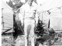 William Takaezu posing in front of tents at Camp Shelby, Mississippi. [Courtesy of Mrs. William Takaezu]