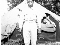 William Takaezu poses in front of a tent at Camp Shelby, Mississippi. [Courtesy of Mrs. William Takaezu]