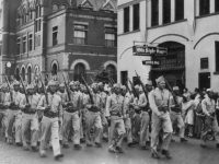 A Co. Parades in La Crosse, Wisconsin in connection with Bond sale Promotion with Abbot an Costello. Parade is led by Capt. Jack Johnson.  [Courtesy of Janice Uchida Sakoda]