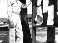 Gary Uchida checks out the bulletin board at Camp McCoy, Wisconsin, September 1942. [Courtesy of Janice Uchida Sakoda]