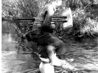 Gary Uchida and Stanley cross a stream. Inscription:Reverse: Me on Stanley. I am not pulling rank. Stanley wanted to go home cross country & promised he would carry me over if we encountered a stream. Here's the result. [Courtesy of Janice Uchida Sakoda]
