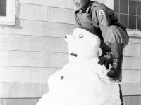 Gary Uchida and snowman, Camp McCoy, Wisconsin. Our first snow; our first snowman on Thanksgiving Day, Nov. 1942. [Courtesy of Janice Uchida Sakoda]