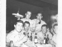 The baseball team at the Golden Gate Club after they were invited by the citizens of Wisconsin Rapids. From left, Hide, Kanashina, Mushy, Sam Tomai.  Standing, Mizusawa and Joe Takata. Inscription: invited to golden gate club after the game by citizens of wisconsin rapids. the beer and drinks on the table were borrowed from the neighboring table...we’re not allowed to drink during ball season. hide, kanashina, mushy, sam. standing- mizusawa and joe  [Courtesy of Sandy Tomai Erlandson]