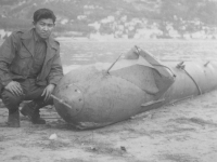 21 Dec. 44 - France, Menton.  Me and the sub. It's more of a human torpedo operated by a electric motor.  The batteries are just back of the cockpit.  The controls are like those on airplane.  Herbert Sueoka.  [Courtesy of Herbert Sueoka]