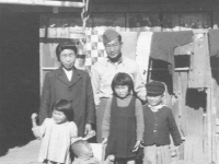 Tom Matsumura with a Japanese family. [Courtesy of Florence Matsumura]